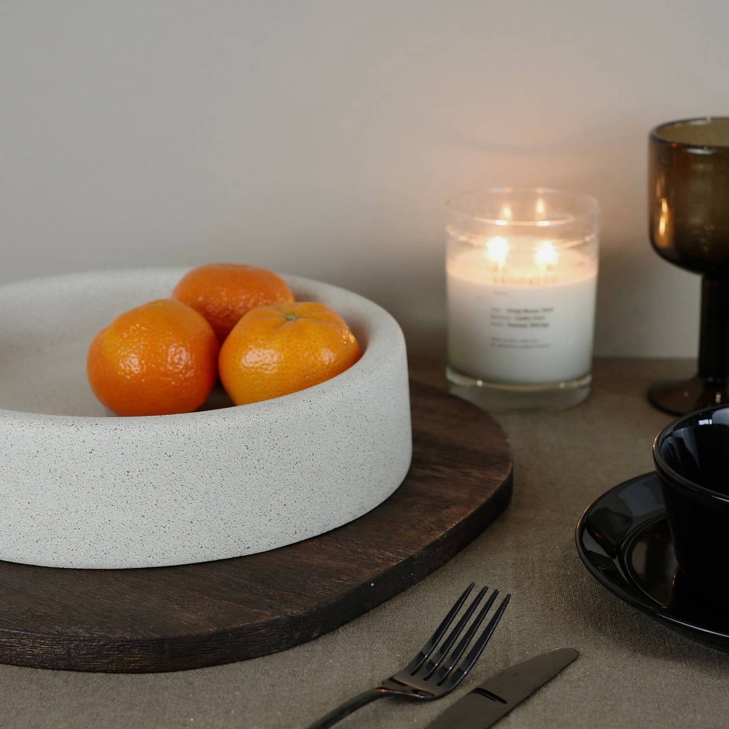 Beige round eco concrete fruit bowl on a table 