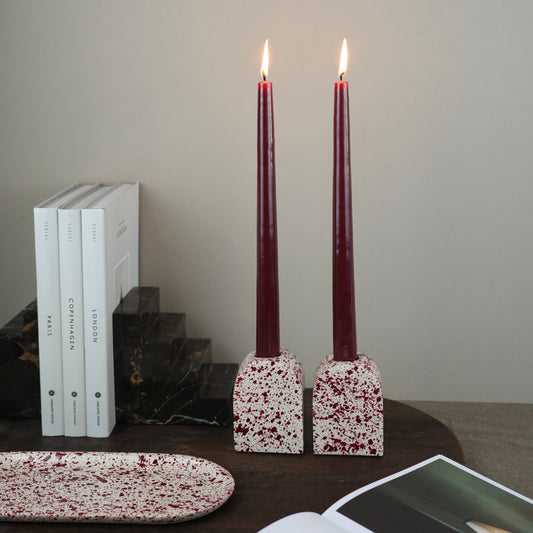 Burgundy paint splattered on a cream concrete large arch shaped candleholder, pair