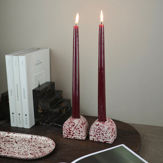 Burgundy paint splattered on a cream concrete small arch shaped candleholder, pair