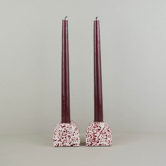 Burgundy paint splattered on a cream concrete small arch shaped candleholder, pair